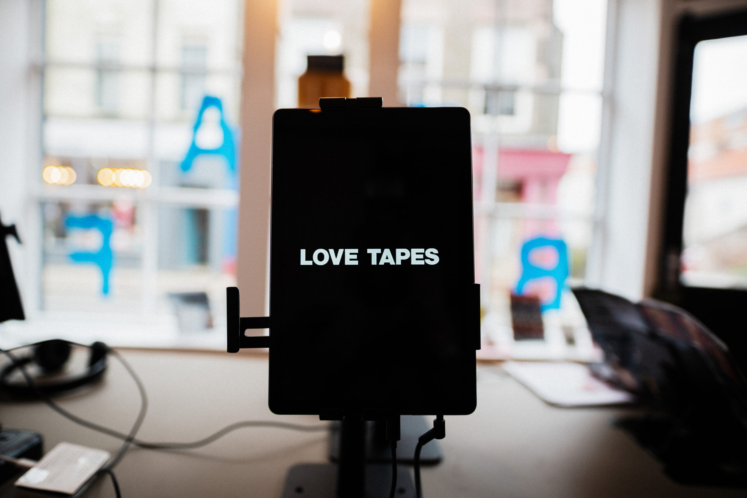 an ipad screen that says "love tapes" on it in white text on black background