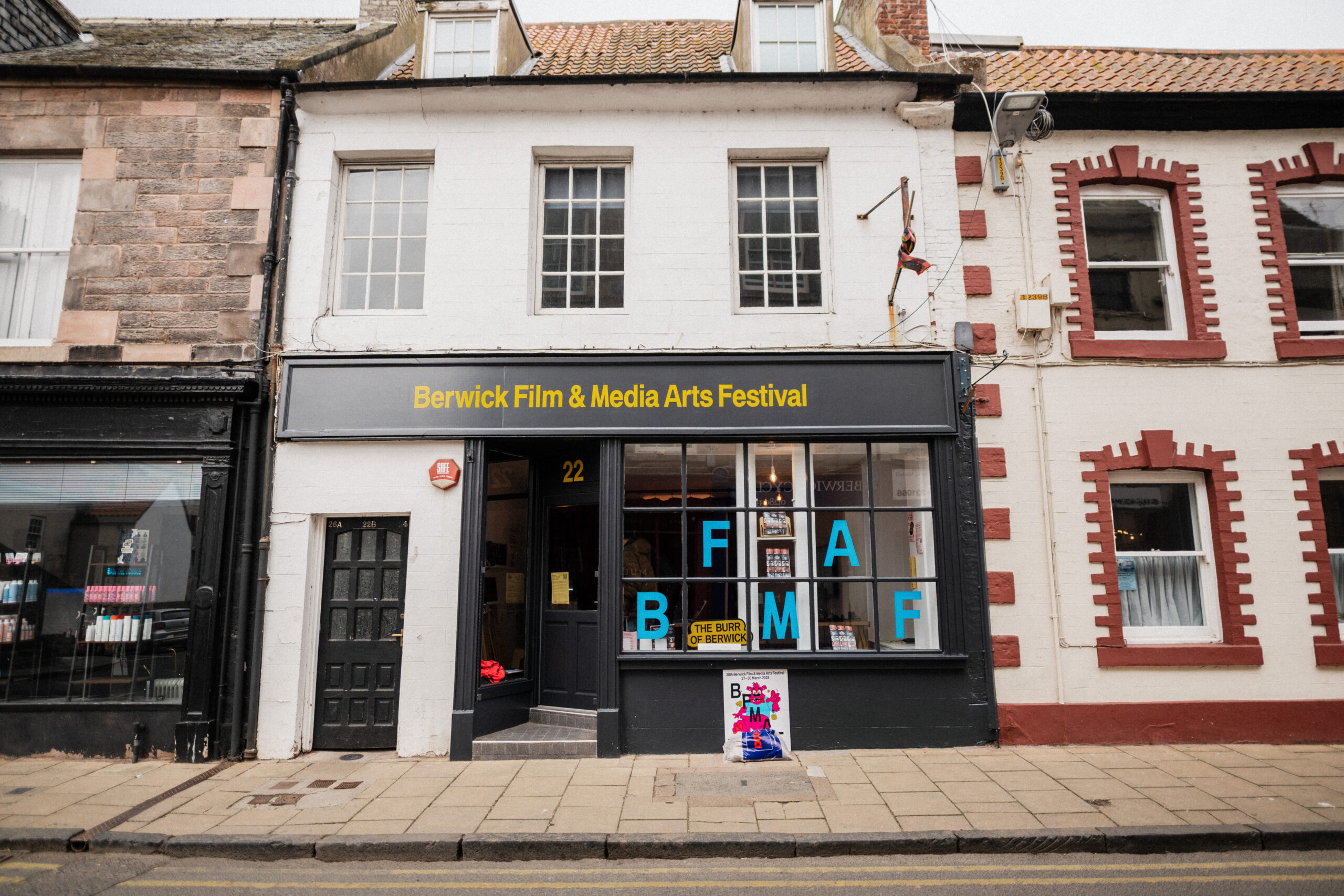 front facade of the BFMAF venue on 22 bridge street. the sign reads "Berwick Film & Media Arts Festival" in yellow