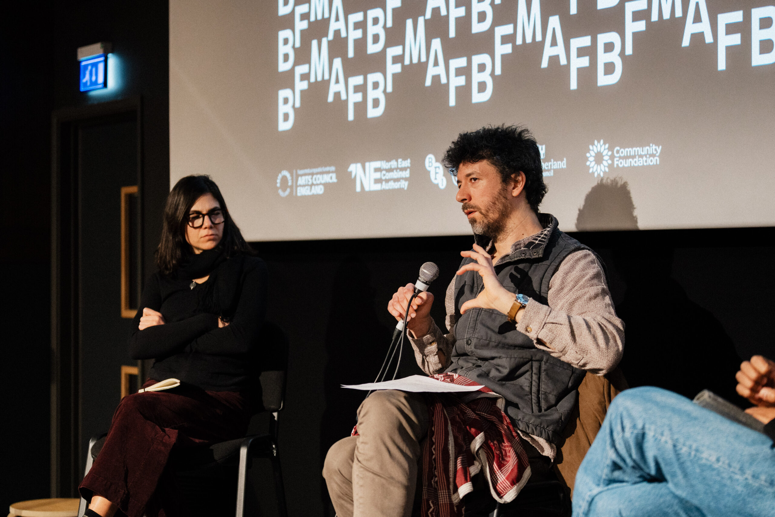 Philip Rizk on stage in conversation with Mai Taha