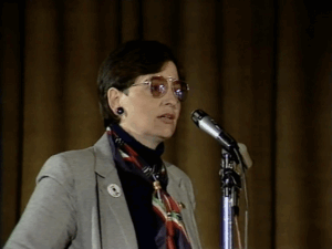 A woman speaking into a microphone